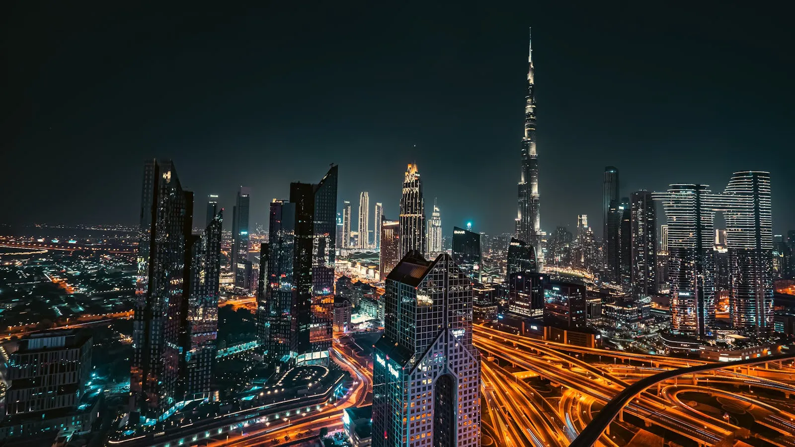 Dubai downtown skyline at night with Burj Khalifa and traffic light trails, representing the 24/7 operations of a running holiday home portfolio