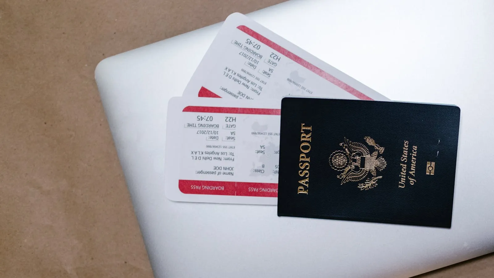 Passport and travel documents on a laptop, representing the guest documentation required for Dubai holiday home DET registration